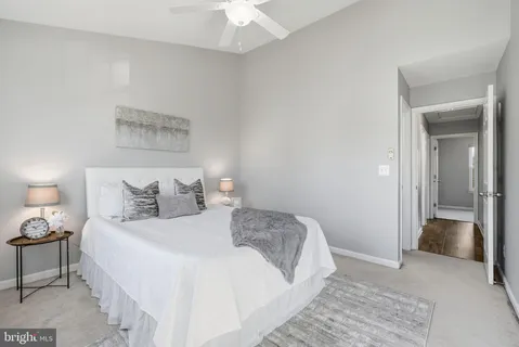 a bedroom with a bed and a lamp