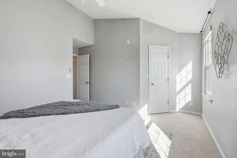 a bedroom with a bed and a large mirror