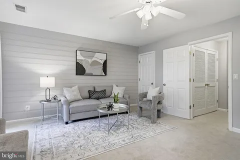 a living room with furniture and white walls