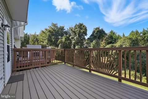 a balcony with wooden floor and fence