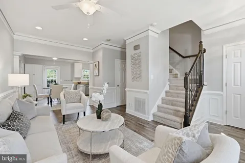 a living room with furniture and a mirror