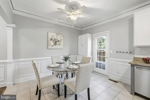 a view of a dining room with furniture and a chandelier fan