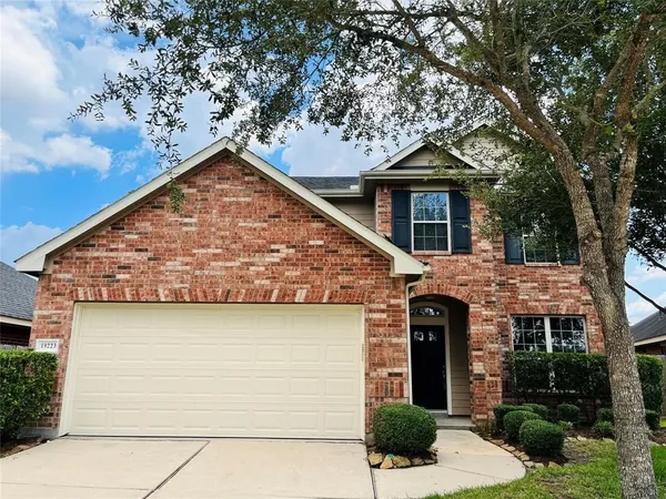 a brick house with a tree in front of it