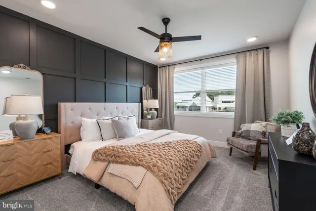 a bedroom with a bed couch and window