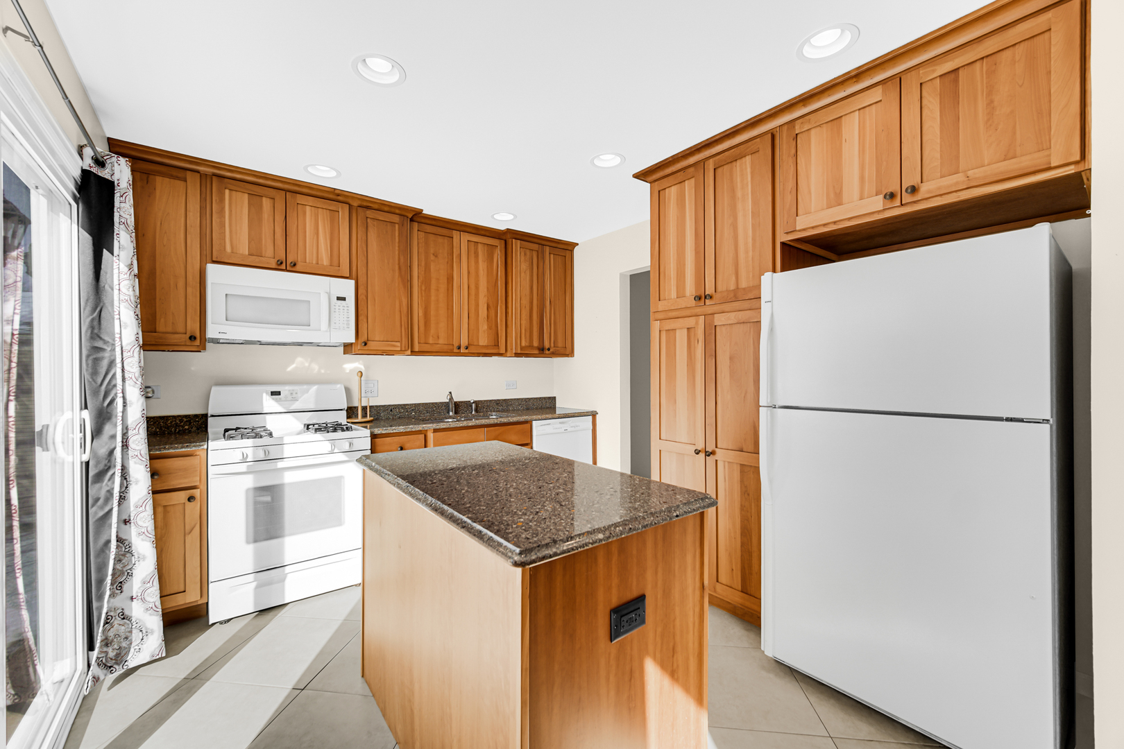 244 Lincoln Drive Bartlett, IL 60103 - Photo 8 of 24 a kitchen with a refrigerator a stove a sink and cabinets