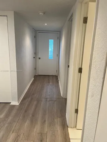 a view of a room with wooden floor