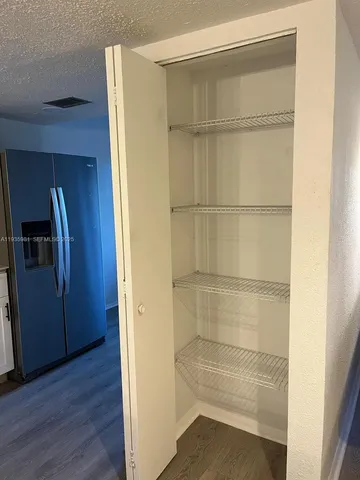 a view of a room with wooden floor