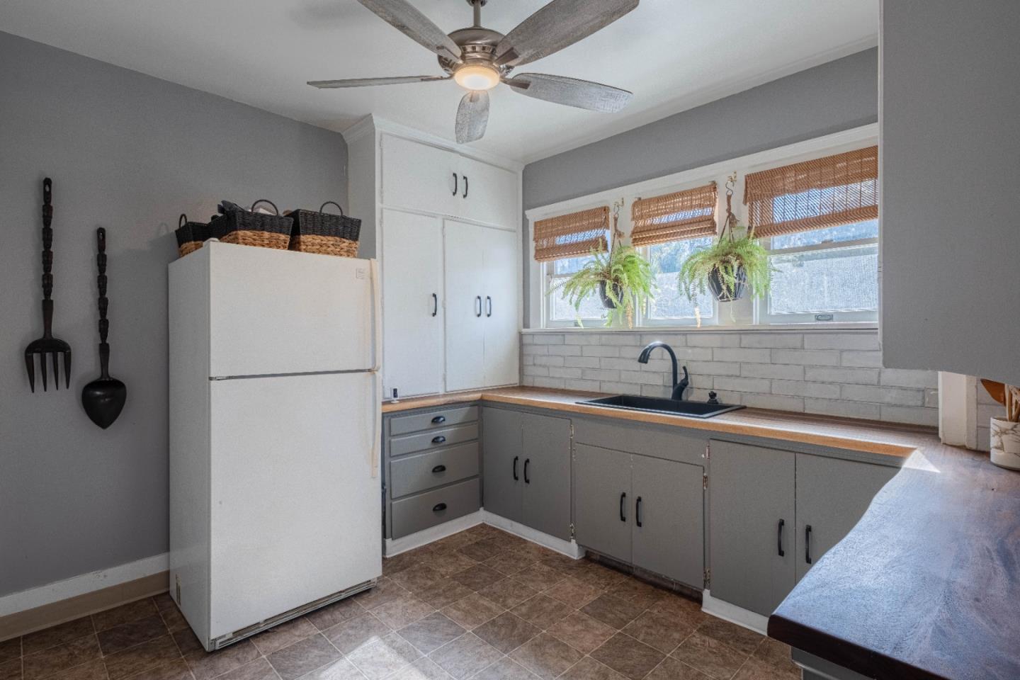 18 Chestnut Street Salinas, CA 93901 - Photo 12 of 32 a kitchen with a refrigerator a sink and a large window