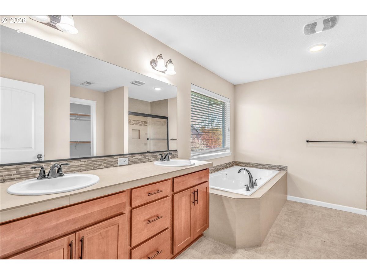 33955 Southeast Vine Street Scappoose, OR 97056 - Photo 23 of 44 a bath room with a sink double vanity granite tub and a mirror