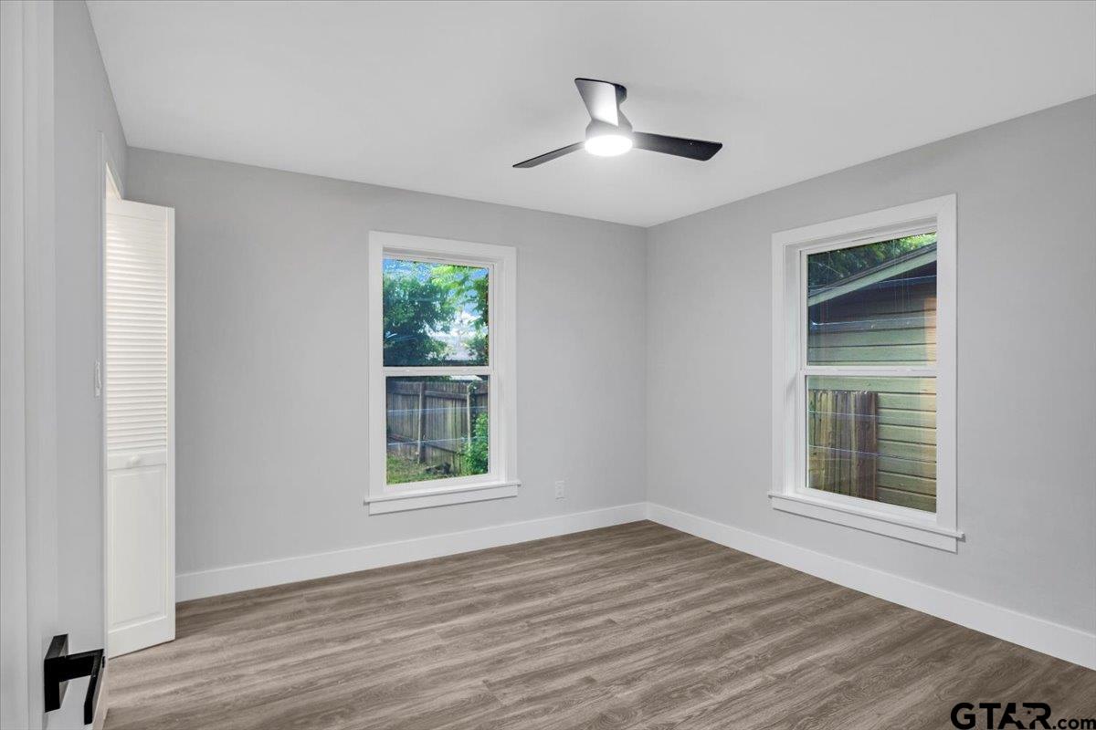 2308 Lingner Drive Tyler, TX 75701 - Photo 11 of 27 a view of an empty room with wooden floor and a window