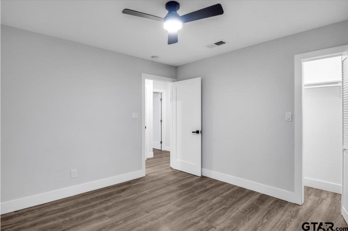 2308 Lingner Drive Tyler, TX 75701 - Photo 13 of 27 an empty room with wooden floor and windows