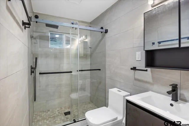 a bathroom with a sink toilet and shower