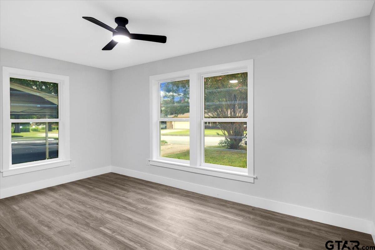 2308 Lingner Drive Tyler, TX 75701 - Photo 15 of 27 a view of a big room with wooden floor and windows in it