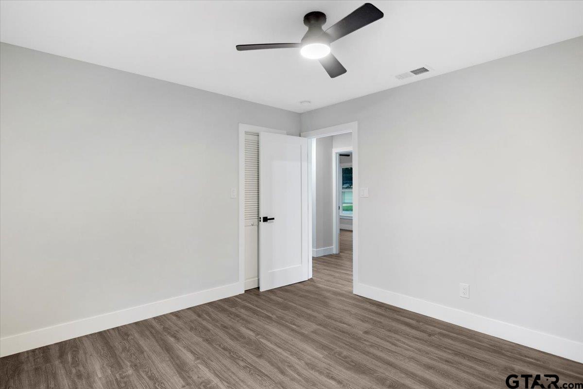 2308 Lingner Drive Tyler, TX 75701 - Photo 20 of 27 an empty room with wooden floor ceiling fan and window