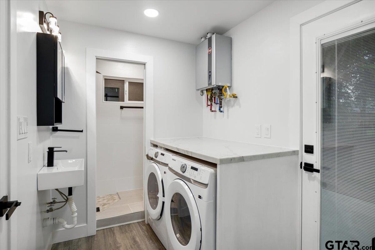 2308 Lingner Drive Tyler, TX 75701 - Photo 22 of 27 a view of washer and dryer with kitchen in the background