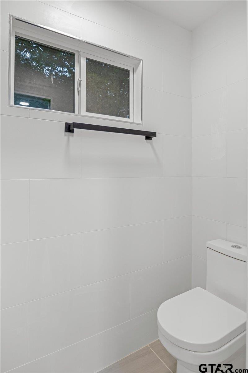2308 Lingner Drive Tyler, TX 75701 - Photo 25 of 27 a white toilet sitting next to a shower