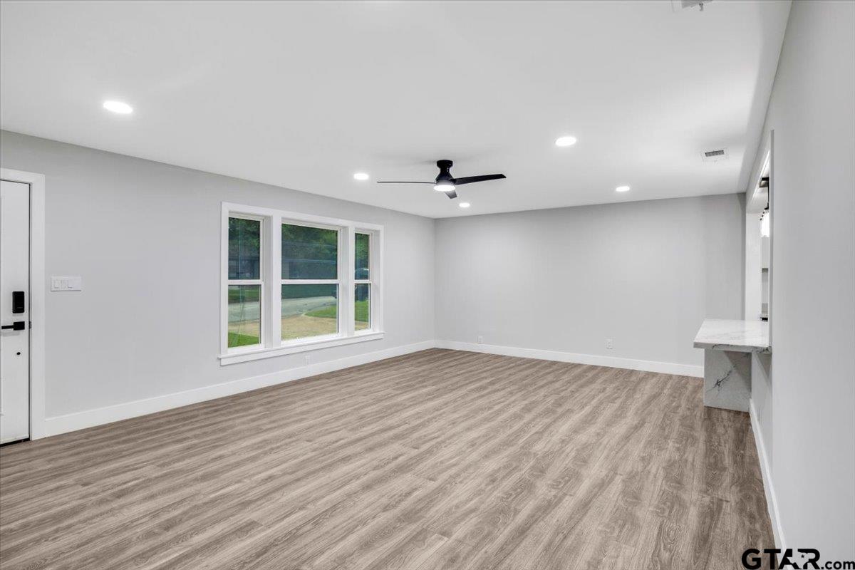 2308 Lingner Drive Tyler, TX 75701 - Photo 4 of 27 wooden floor in an empty room with a window