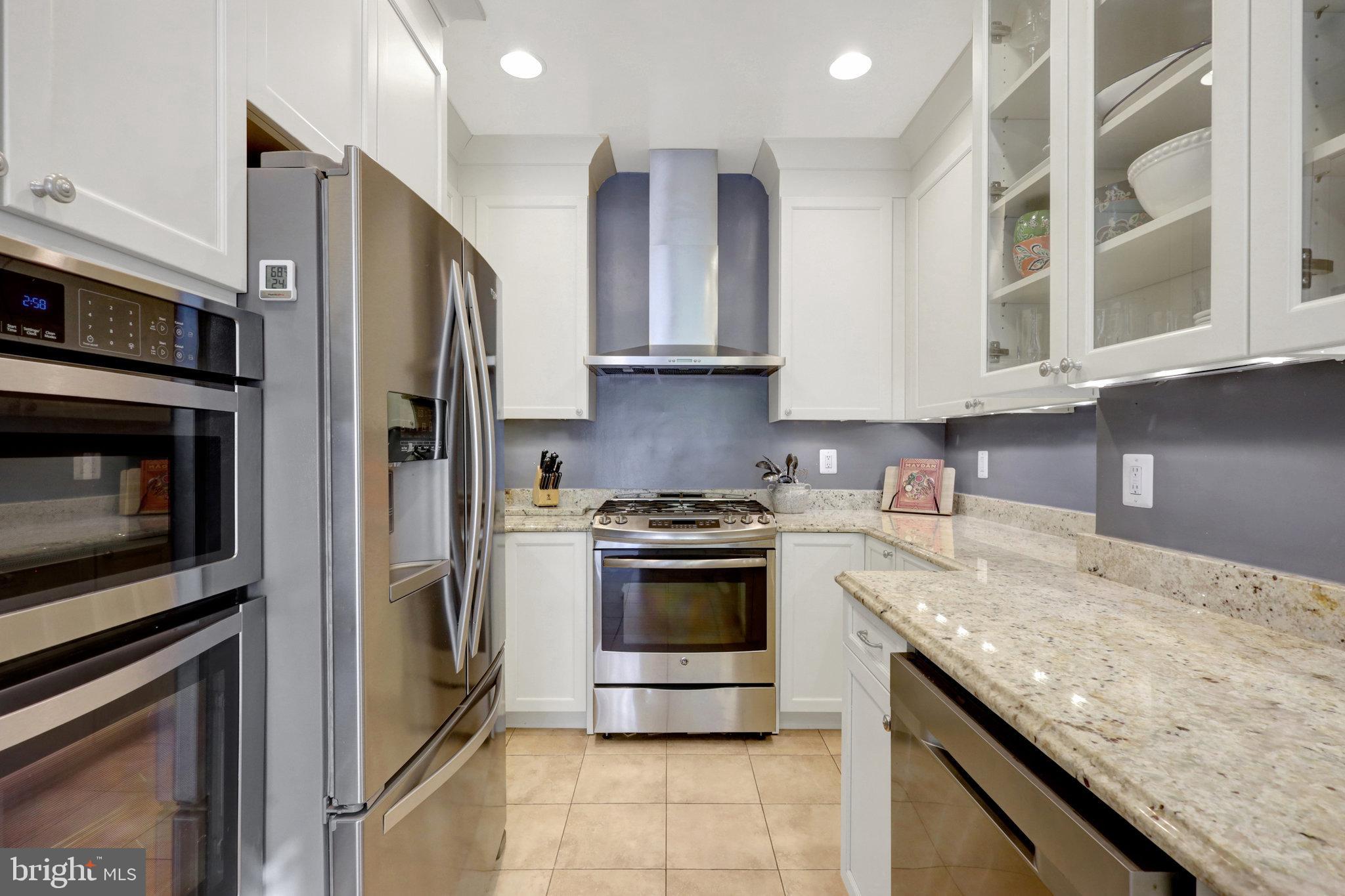 11 6th Street Southeast Washington, DC 20003 - Photo 16 of 48 a kitchen with stainless steel appliances granite countertop a stove microwave and refrigerator