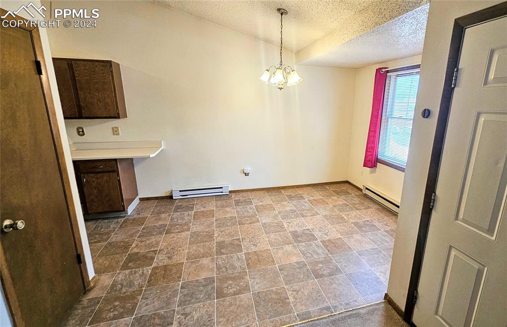 401 Forest Edge Road, Unit B8 Woodland Park, CO 80863 - Photo 7 of 19 a view of empty room with a fireplace and flat screen tv