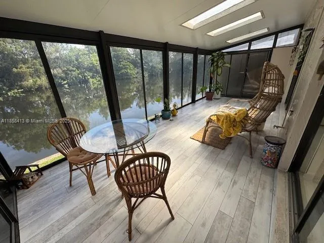 a dining room with furniture and wooden floor