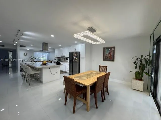 a dining room with furniture and a kitchen