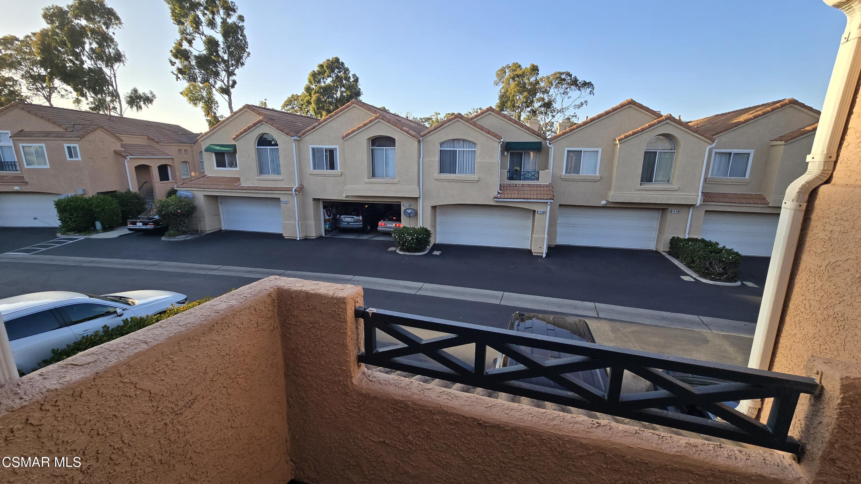 1212 Nautical Way Oxnard, CA 93030 - Photo 13 of 16 a view of a white house with a large pool and a wooden bench