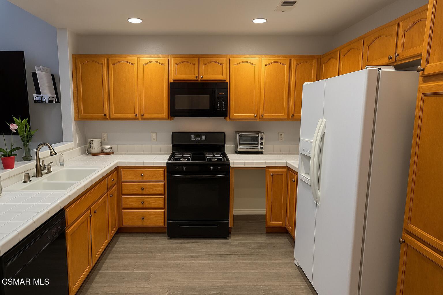 1212 Nautical Way Oxnard, CA 93030 - Photo 5 of 16 a kitchen with stainless steel appliances a refrigerator and a sink