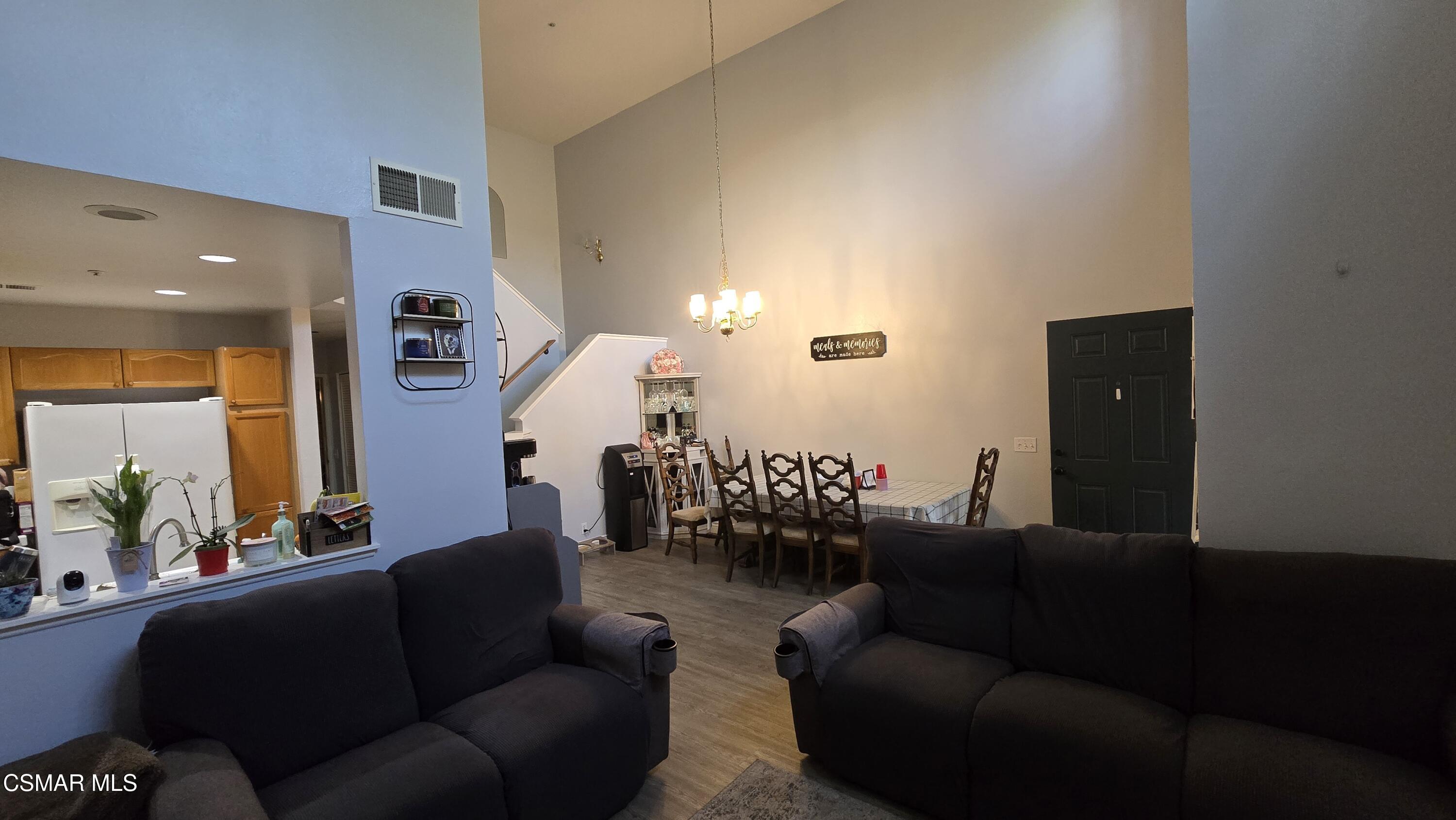 1212 Nautical Way Oxnard, CA 93030 - Photo 7 of 16 a living room with furniture and a chandelier