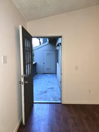 an empty room with wooden floor and closet