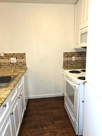 a view of a kitchen with stove top oven