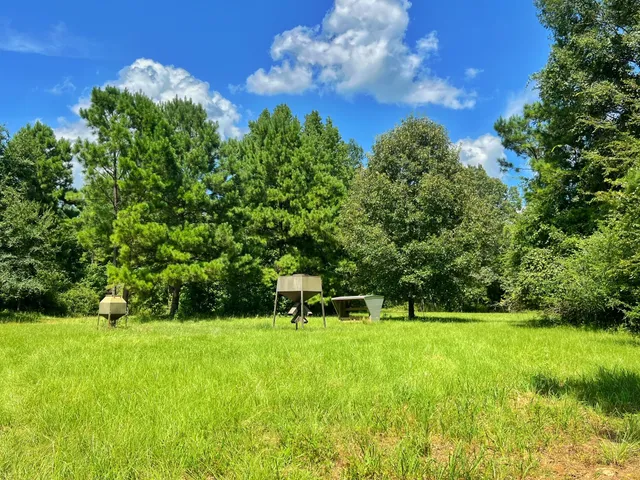 a view of green field with sitting area