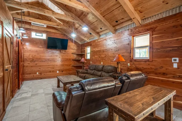 a backyard of a house with barbeque oven table and chairs