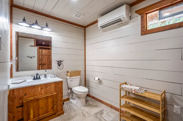 an aerial view of residential houses with outdoor space and trees all around