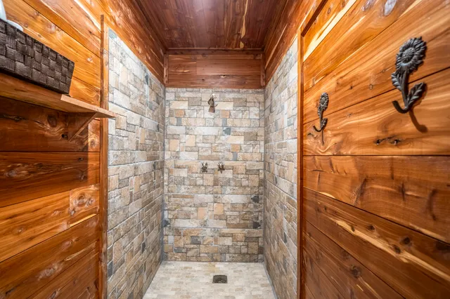 a view of a lush green forest from a balcony