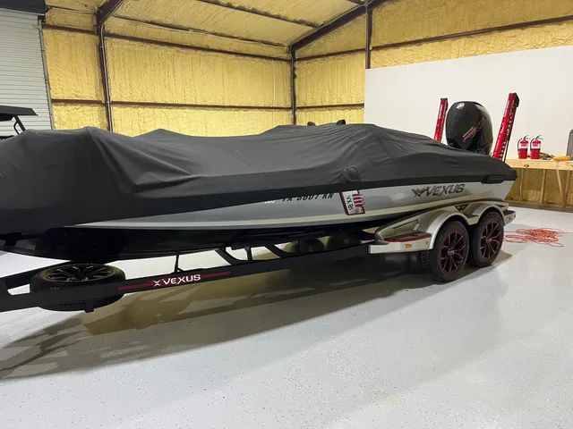 a hallway with a chair and a potted plant