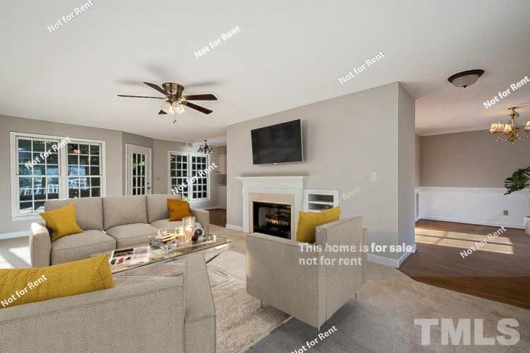1945 Jupiter Hills Court Raleigh, NC 27604 - Photo 2 of 19 a living room with furniture a fireplace and a flat screen tv