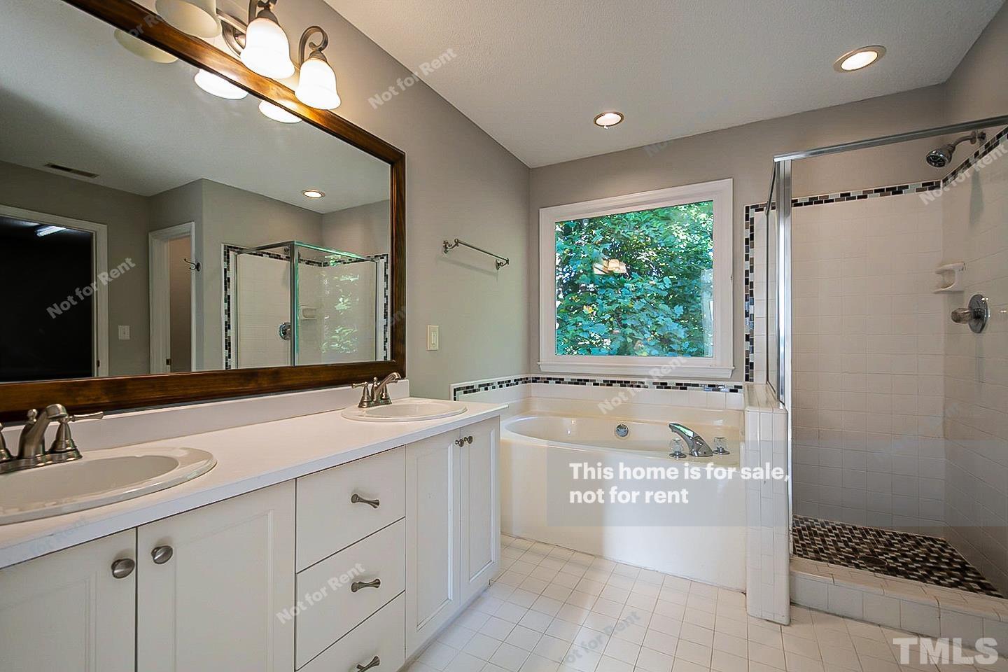 1945 Jupiter Hills Court Raleigh, NC 27604 - Photo 16 of 19 a bathroom with a double vanity sink mirror and shower
