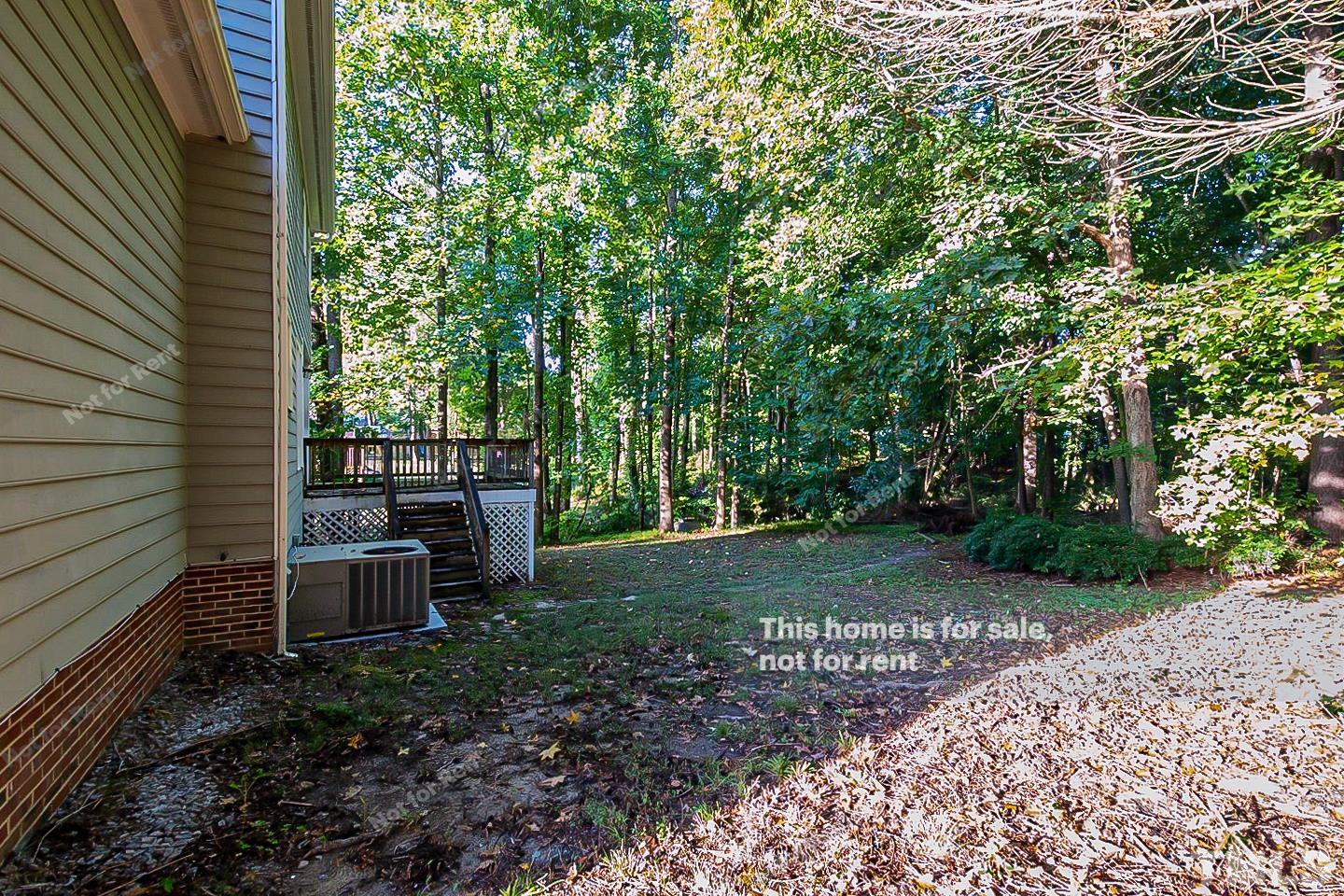1945 Jupiter Hills Court Raleigh, NC 27604 - Photo 18 of 19 a view of a backyard with plants and trees