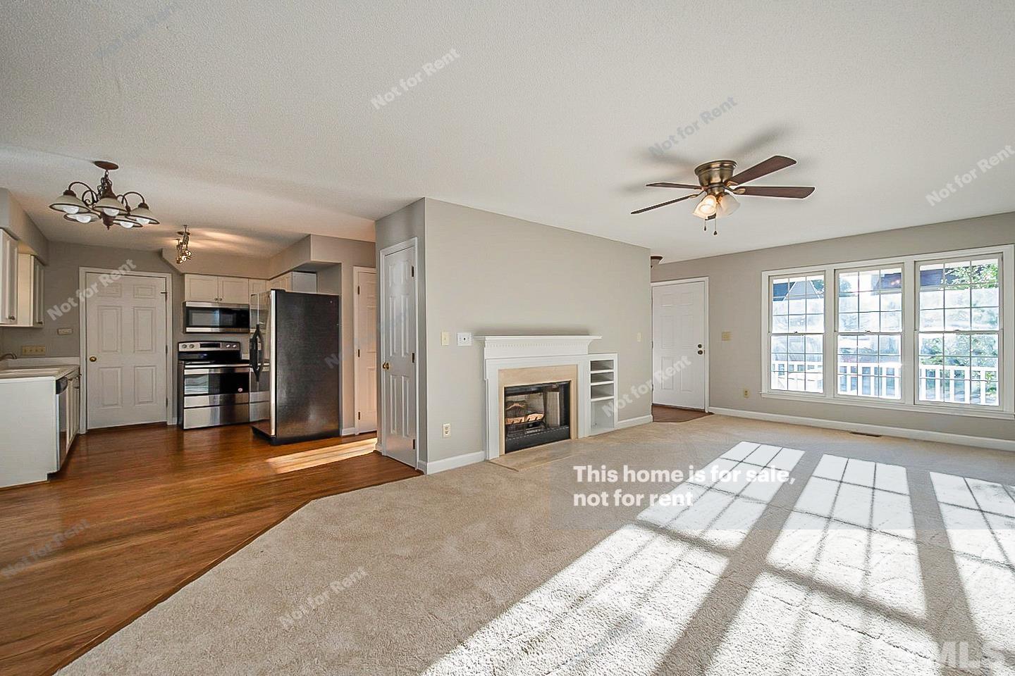 1945 Jupiter Hills Court Raleigh, NC 27604 - Photo 4 of 19 a view of an empty room with a fireplace and a window