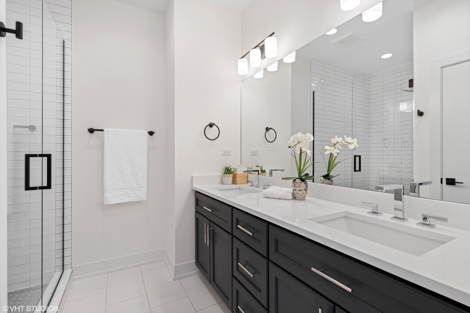 3335-3341 North Sheffield Avenue Chicago, IL 60657 - Photo 15 of 76 a bathroom with a double vanity sink a mirror and shower