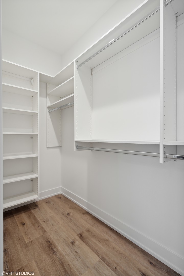 3335-3341 North Sheffield Avenue Chicago, IL 60657 - Photo 17 of 76 a view of an empty room with wooden floor and closet
