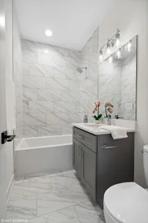 a kitchen with white cabinets and sink