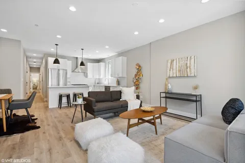 a kitchen that has a sink a stove and a table in it
