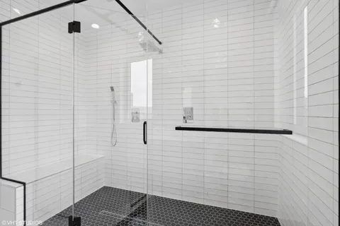 a large kitchen with kitchen island a large counter top space and stainless steel appliances