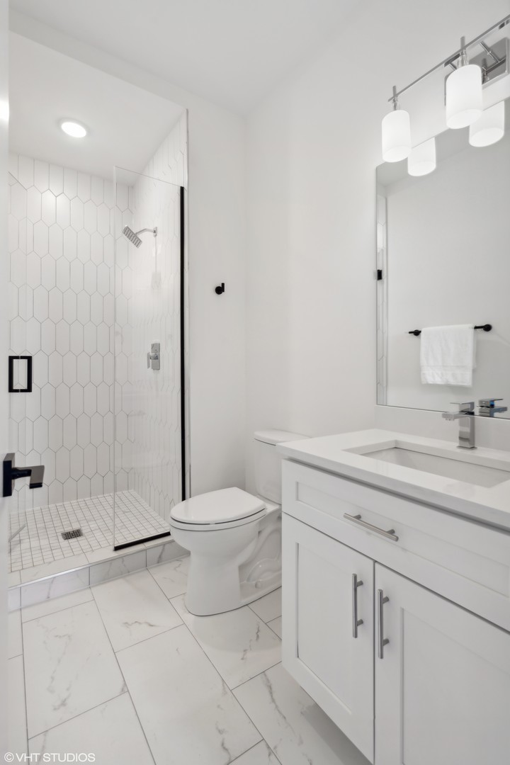 3335-3341 North Sheffield Avenue Chicago, IL 60657 - Photo 46 of 76 a bathroom with a sink a toilet and shower