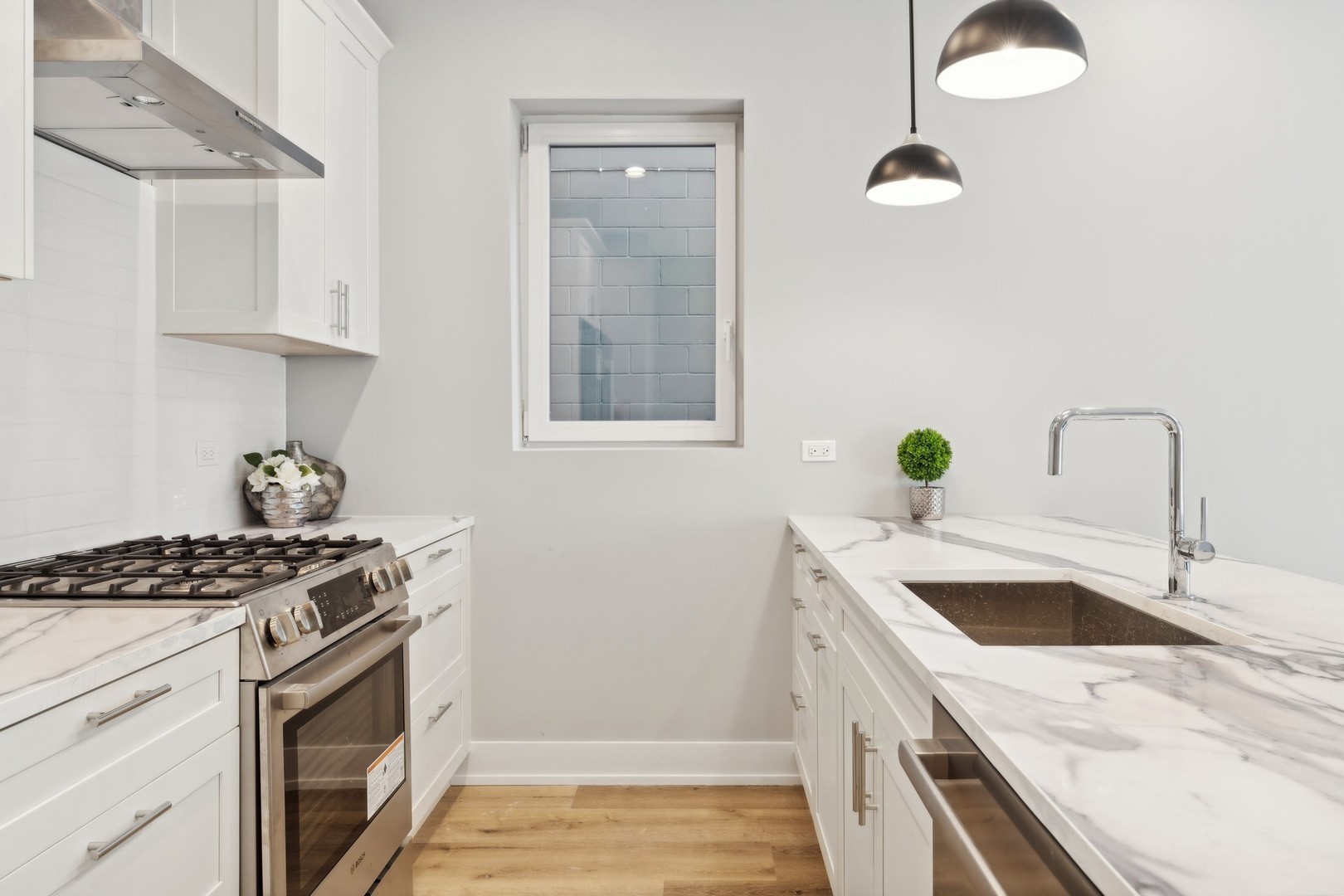 3335-3341 North Sheffield Avenue Chicago, IL 60657 - Photo 64 of 76 a kitchen that has a sink and a stove