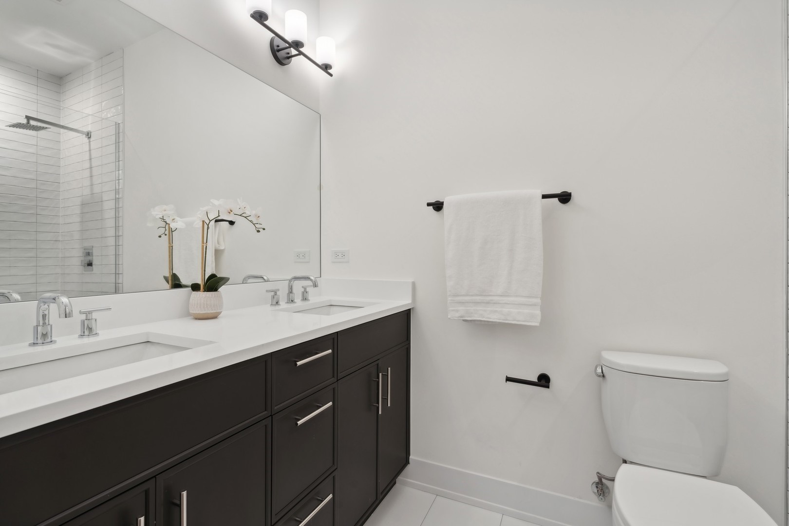 3335-3341 North Sheffield Avenue Chicago, IL 60657 - Photo 70 of 76 a bathroom with a double vanity sink toilet and a mirror