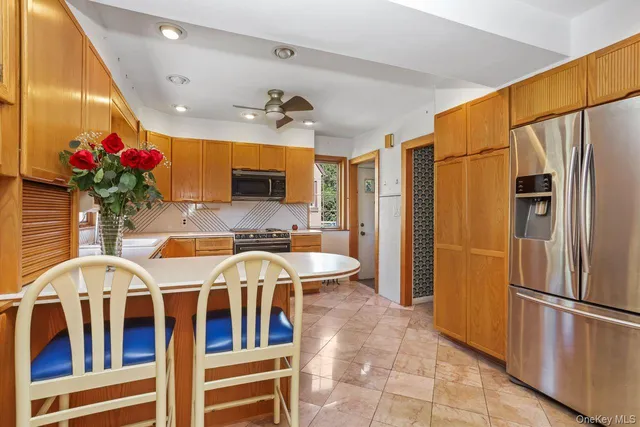 a kitchen with stainless steel appliances granite countertop a sink and refrigerator