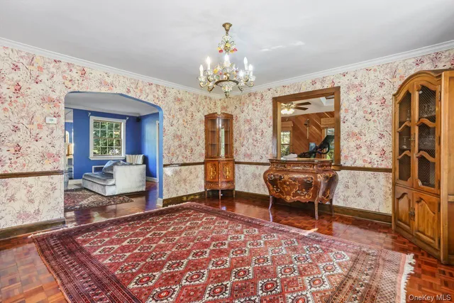 a living room with furniture and a chandelier