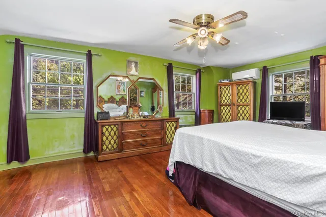 a bed sitting in a bedroom next to a window